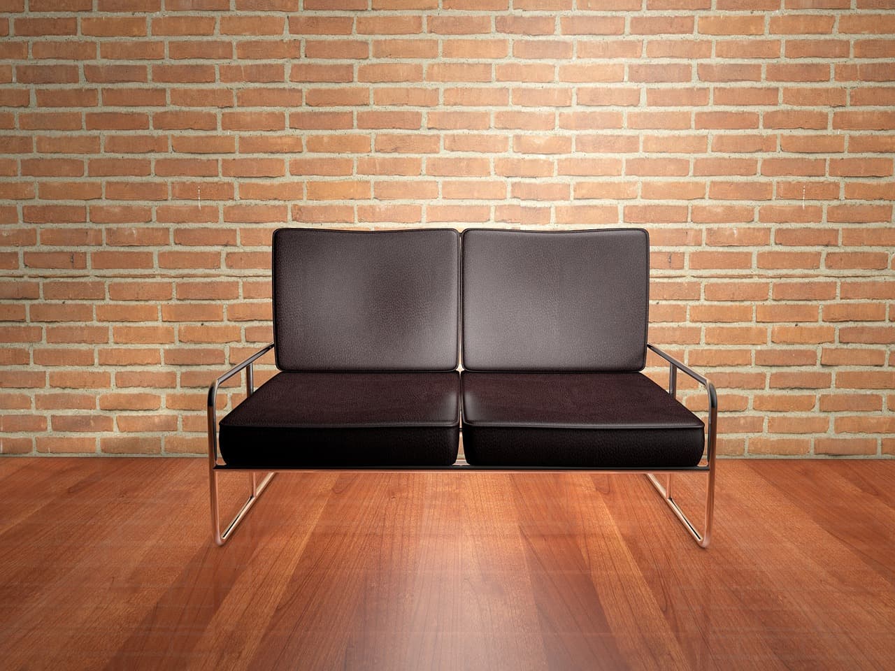 A leather sofa against a brick wall