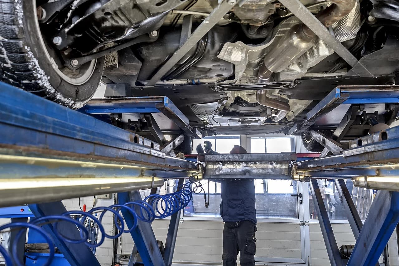 Underside of a car on a lift during an inspection