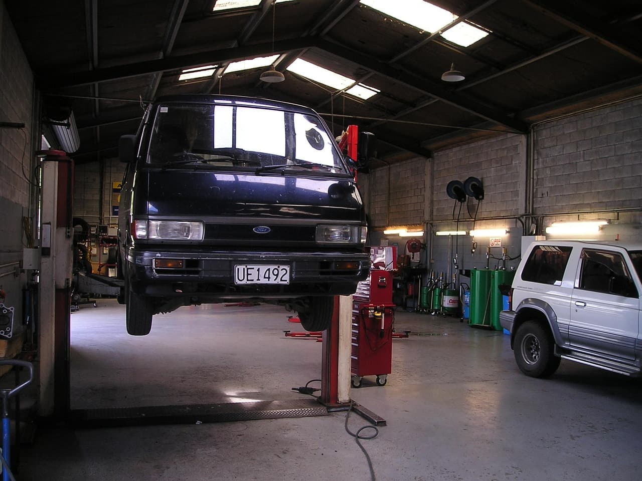 A van raised on a lift in a workshop
